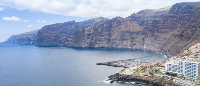 Aerial view of the cliffs of Los Gigantes on Tenerife Spain 48225322512 768x330